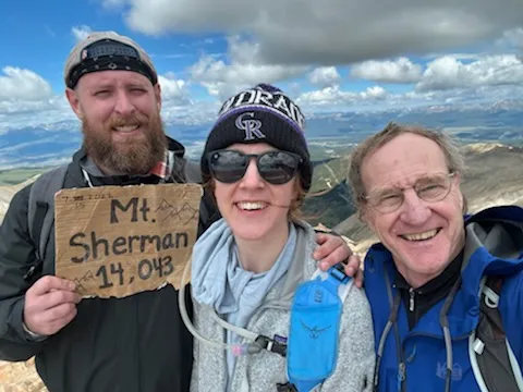 A photo of Kristen, her still insanely fit father, and the barely still-alive me atop Mt. Sherman